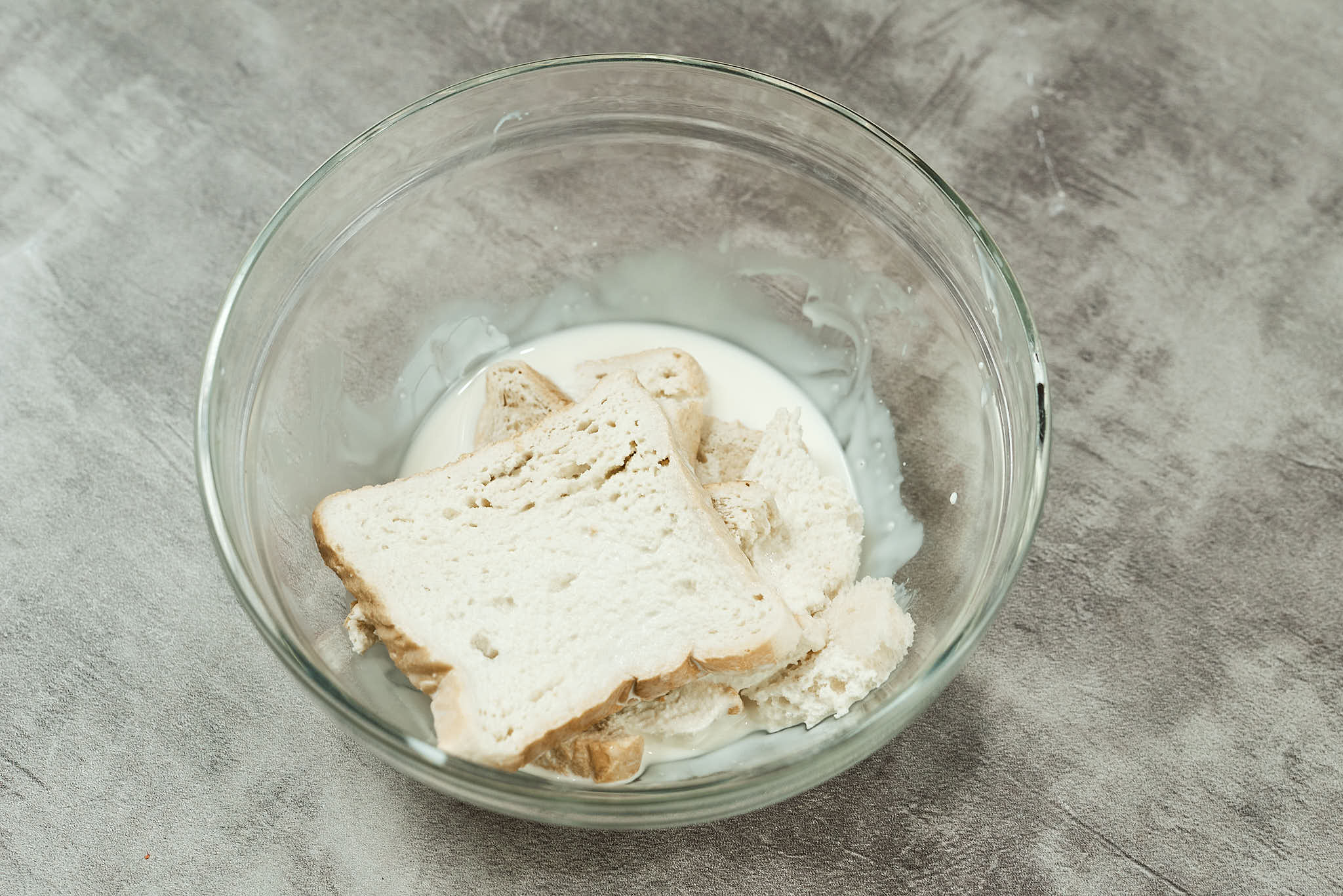 White bread soaking in cream for creamy chicken meatballs