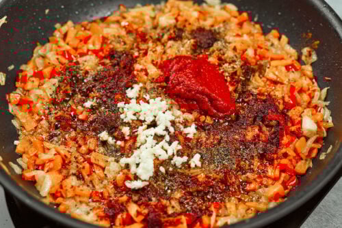 Seasonings and tomato paste added to sauce for chicken meatballs