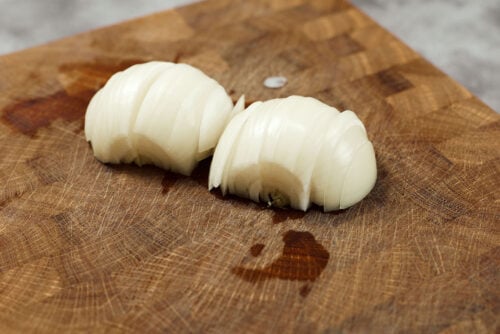 Onion sliced into half rings for chicken meatballs
