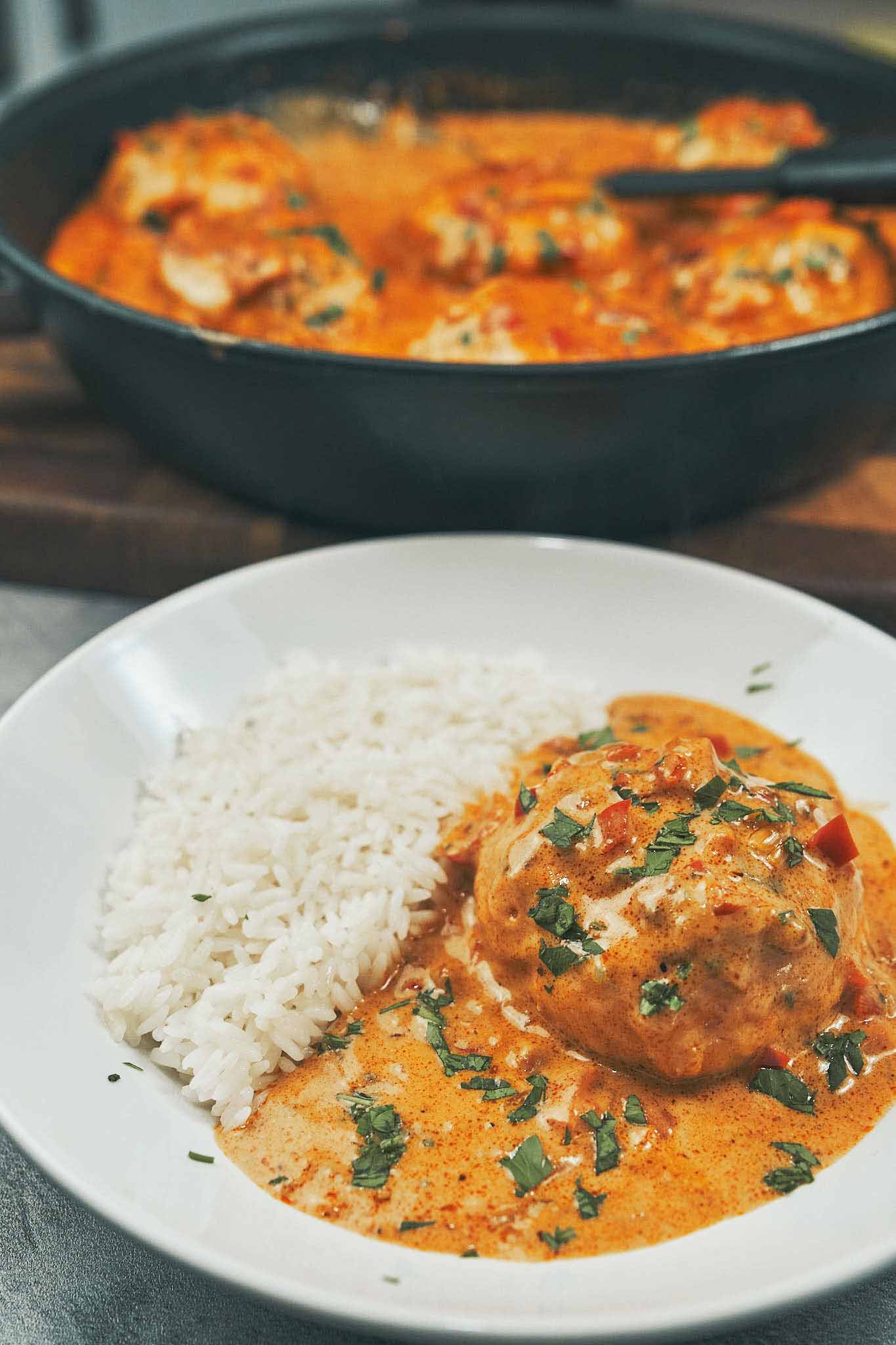 Juicy creamy chicken meatballs in rich cream sauce served with white rice