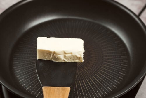 Butter melting in skillet for creamy chicken meatballs
