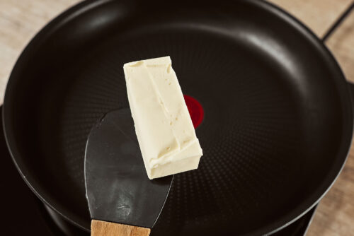 Butter added to a skillet to start the mushroom sauce