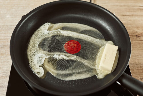Butter melting in a skillet over medium heat