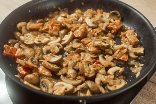 Mushrooms sautéing until tender and lightly golden