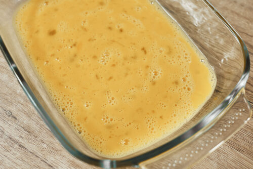 Beaten eggs prepared for breading pork schnitzel