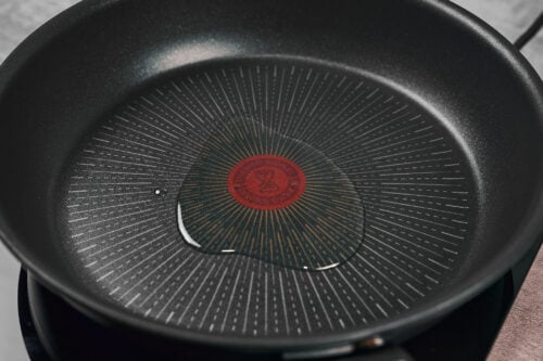 Heating oil in a pan before searing beef stroganoff