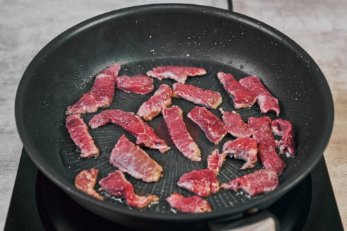 Searing beef strips in a single layer for beef stroganoff