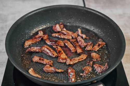 Beef browning in a skillet for classic beef stroganoff
