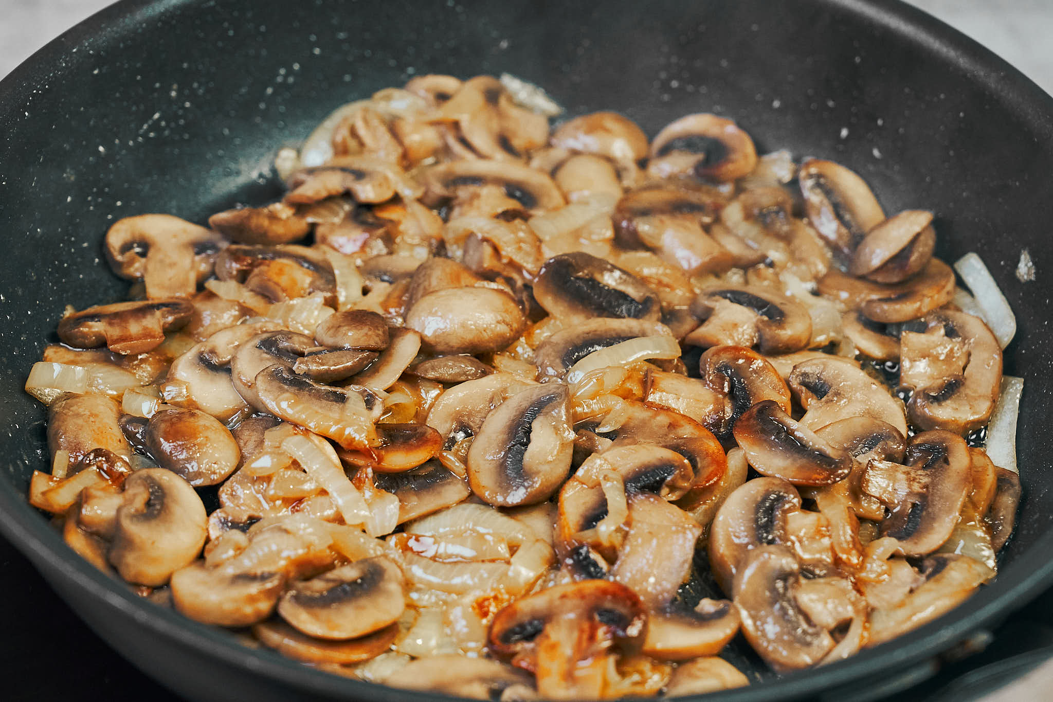 Mushrooms and onions sautéed until golden for beef stroganoff