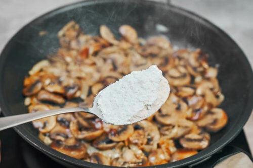 Adding flour to mushrooms for beef stroganoff sauce