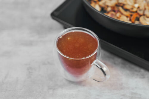 Deglazing mushrooms with broth for beef stroganoff sauce