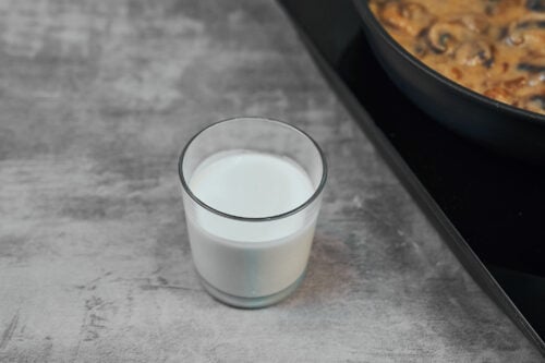 Heavy cream measured for beef stroganoff sauce