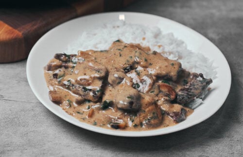Beef stroganoff served over rice with creamy mushroom sauce
