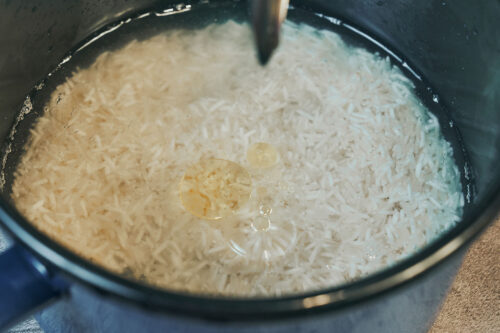 White rice simmering in water with oil