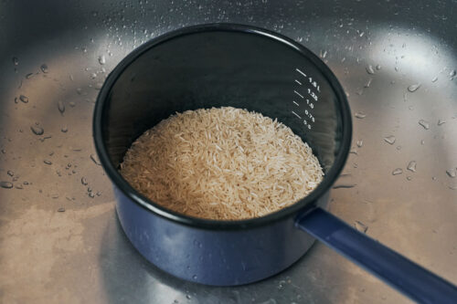 Uncooked white rice in a saucepan before rinsing