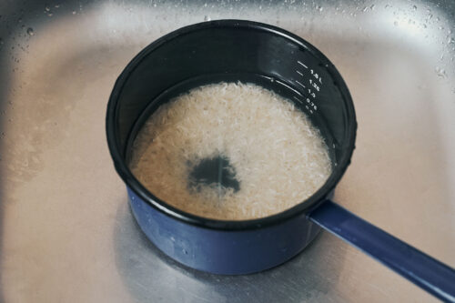 Rinsed rice with water running clear