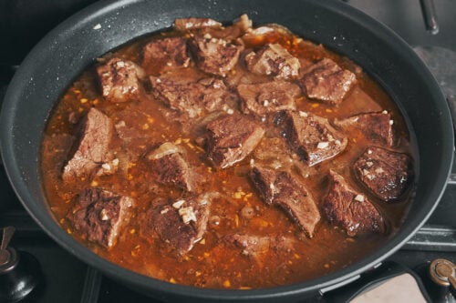 Slow simmered garlic butter beef becoming fork tender