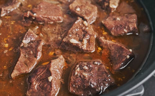 Tender beef chunks cooking in garlic butter sauce