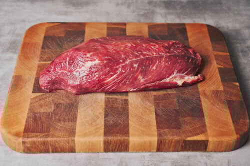 Raw beef chuck on a wooden cutting board