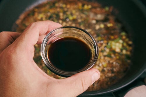 Soy sauce being added to the skillet