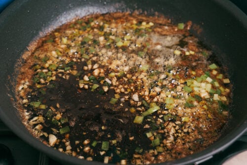 Garlic and green onion cooking in the skillet