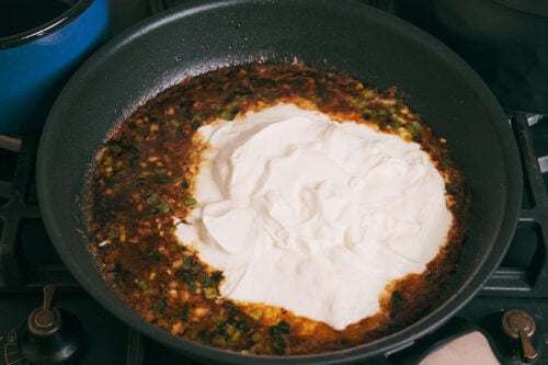 Sour cream added to the skillet to make the sauce