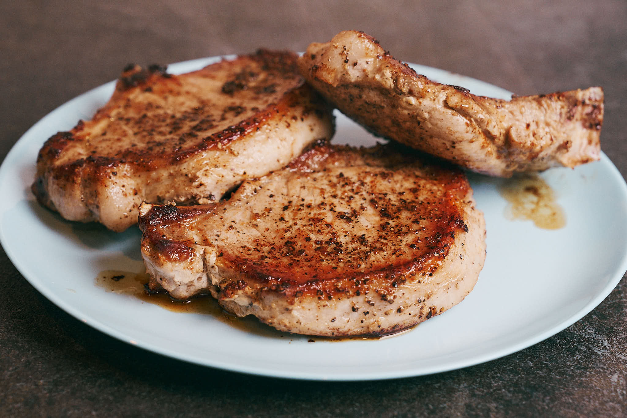 Seared pork chops resting on a plate