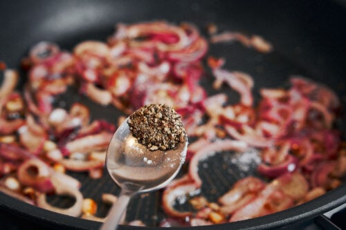 Freshly ground black pepper added to onions while cooking