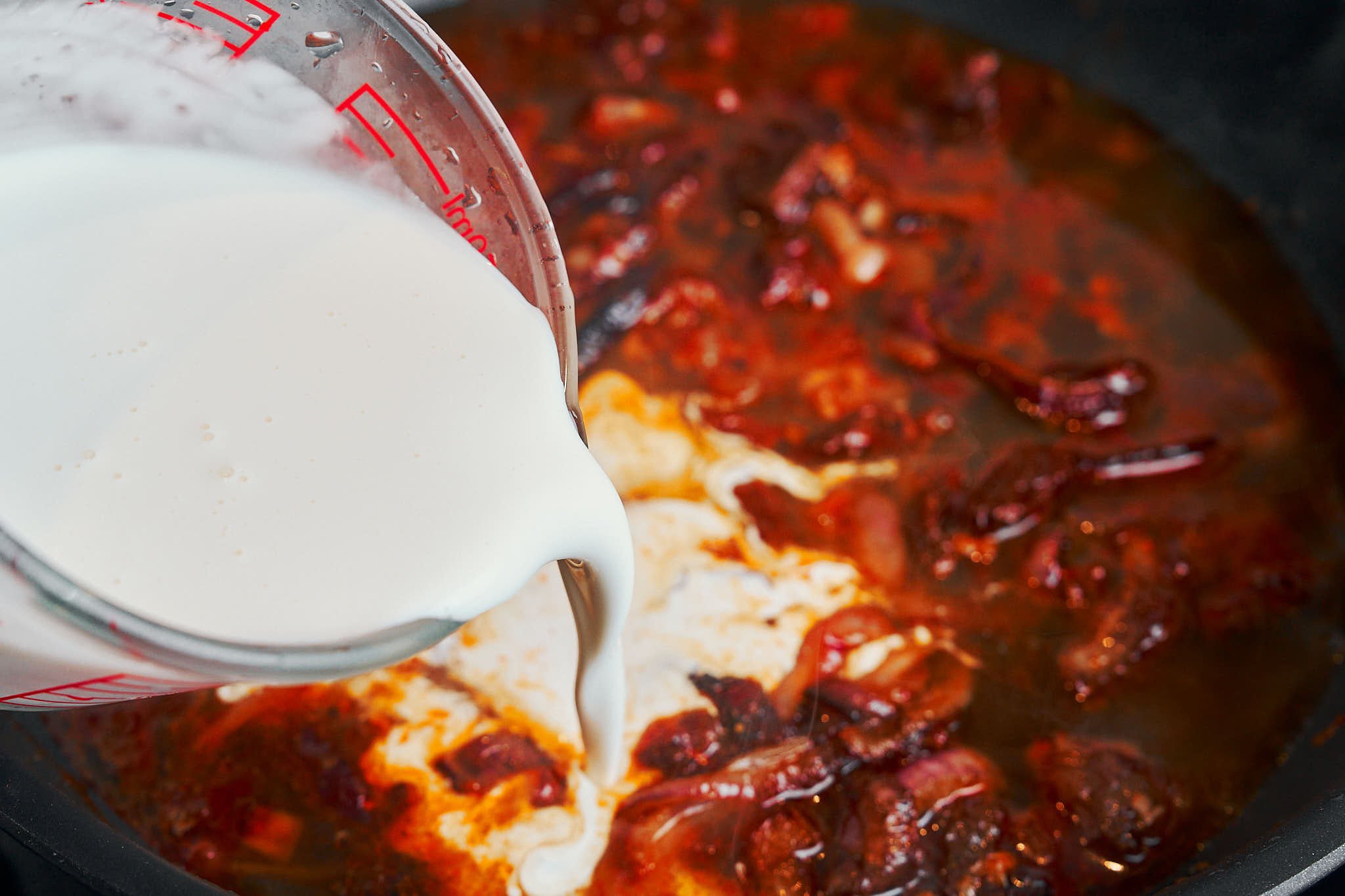 Heavy cream poured into the skillet to create a creamy sauce