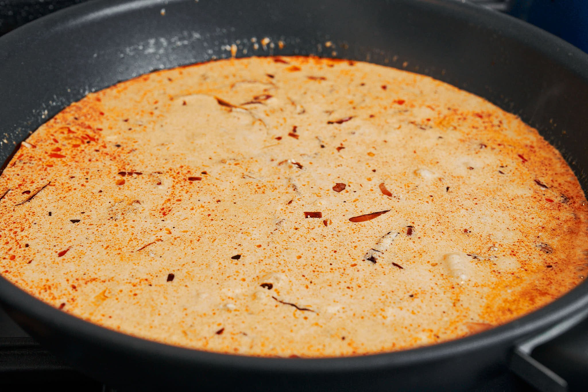 Creamy garlic sauce simmering in the skillet