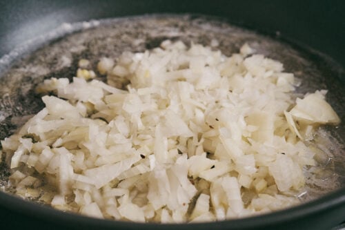 chopped onion cooking in butter in a skillet