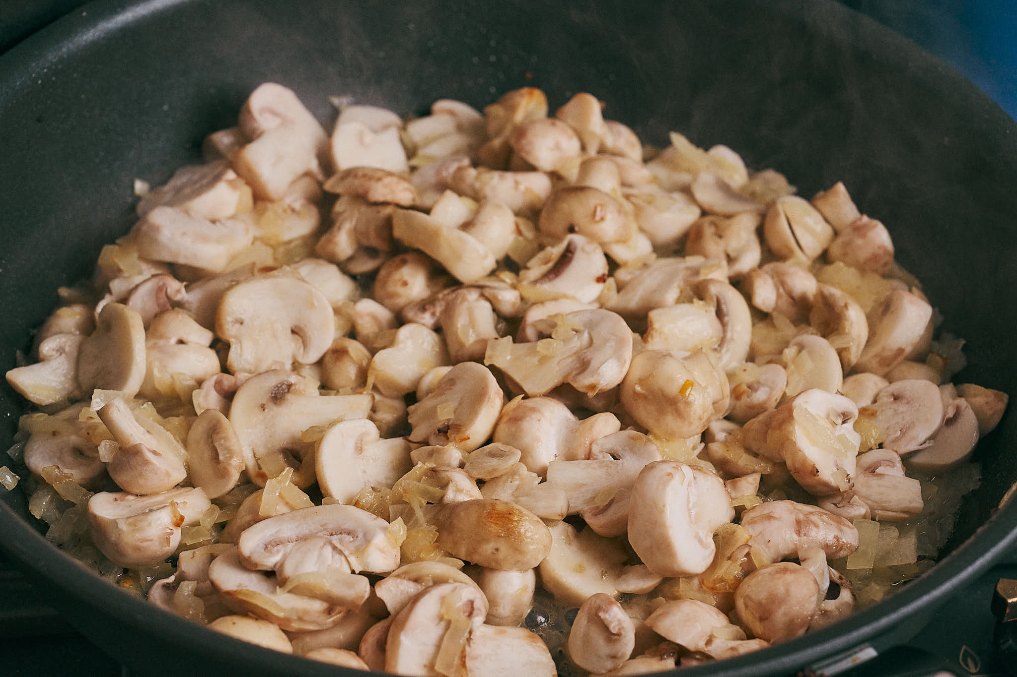 mushrooms cooking with onions as they release moisture