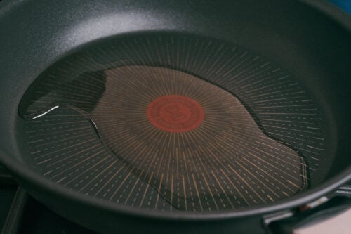 heated skillet with olive oil ready for cooking ground beef