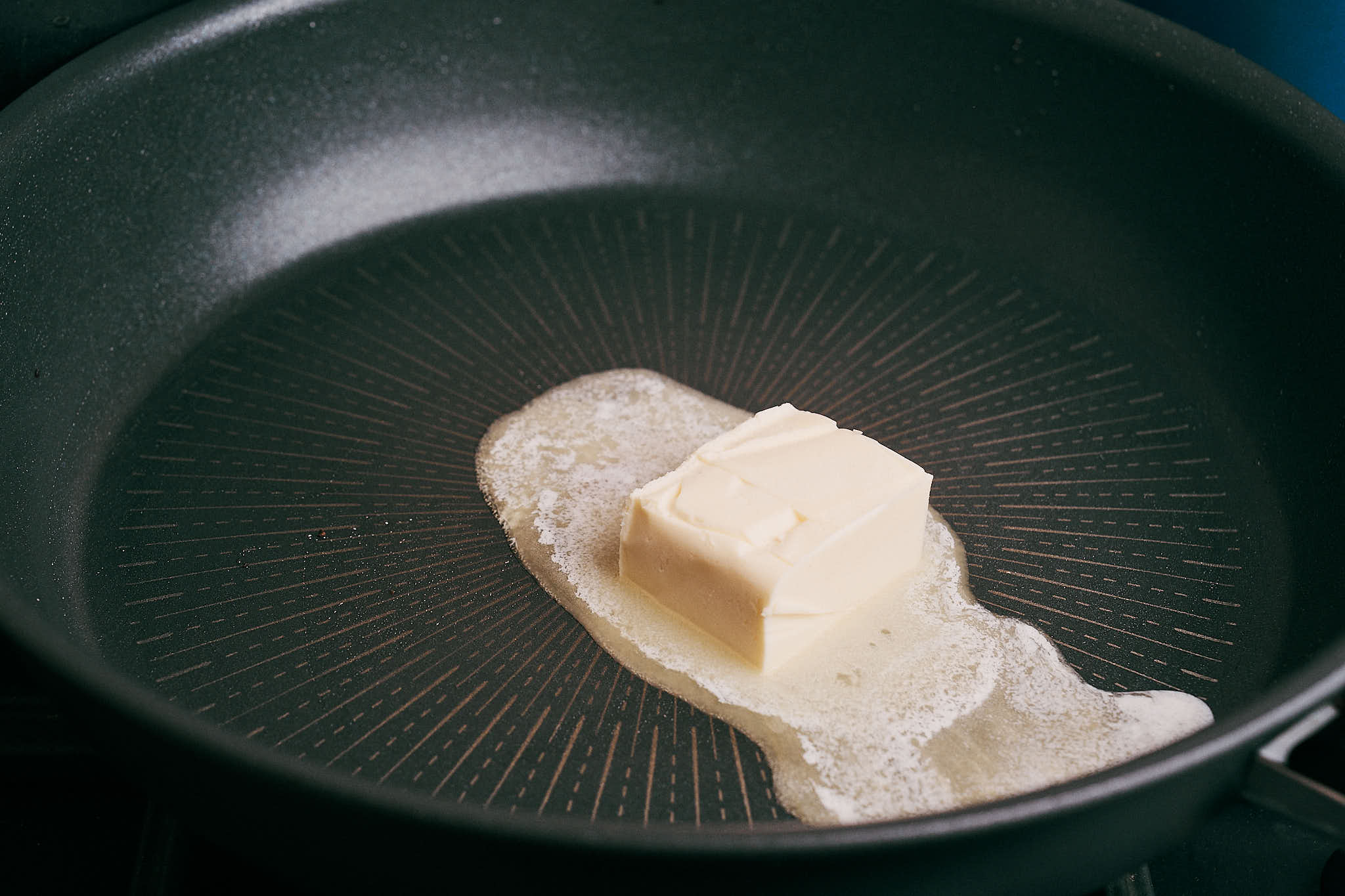 butter melting in a skillet to start the sauce base
