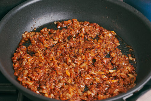 Onions cooking with spices until fragrant