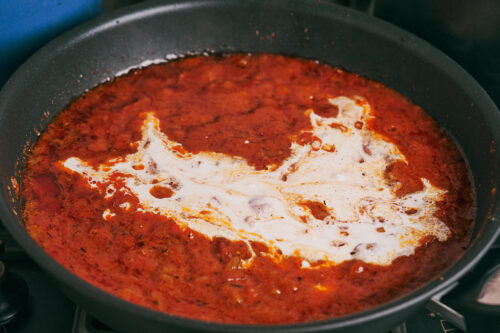 Cream stirred into the sauce