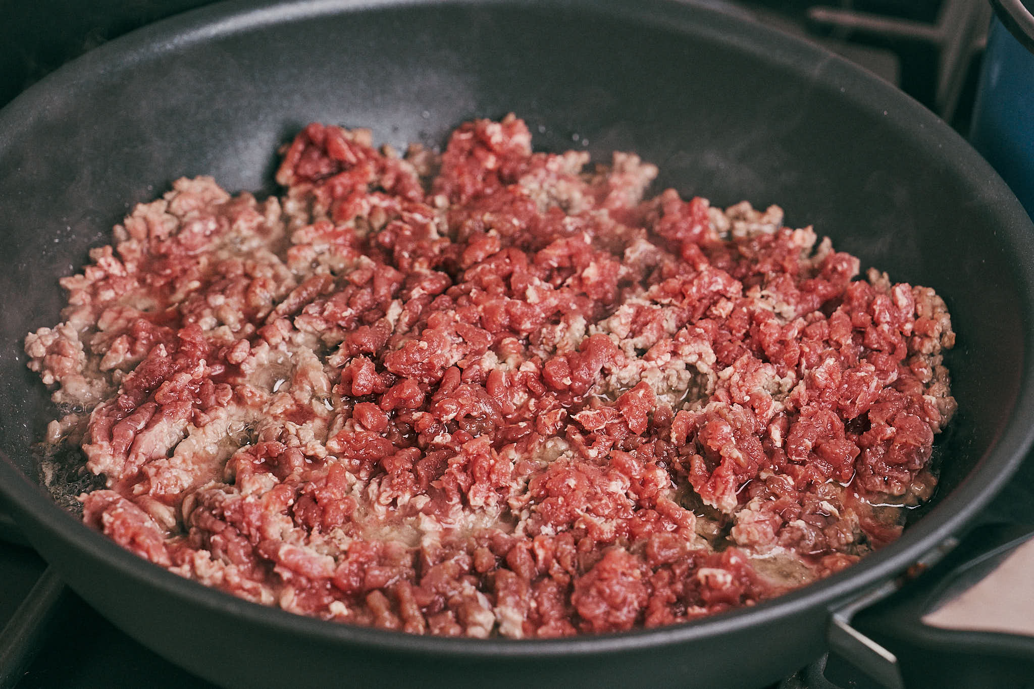 Browning ground beef in a skillet for creamy ground beef pasta
