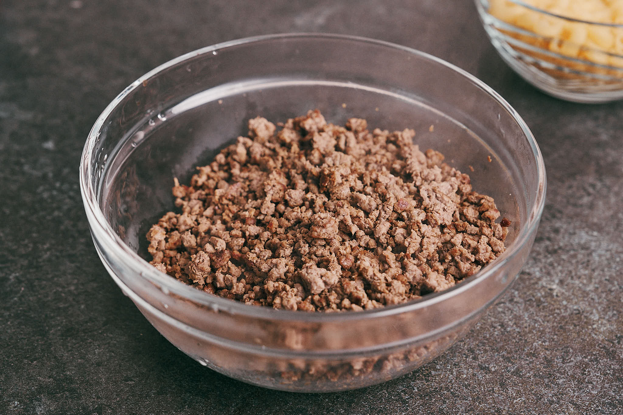 Cooked ground beef transferred to a bowl and set aside