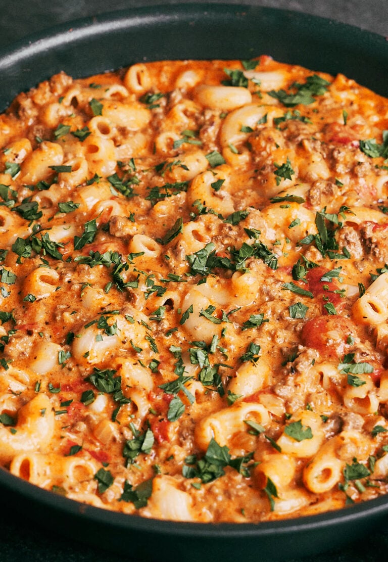 Creamy ground beef pasta with tender macaroni, seasoned beef, and melted cheese in a skillet