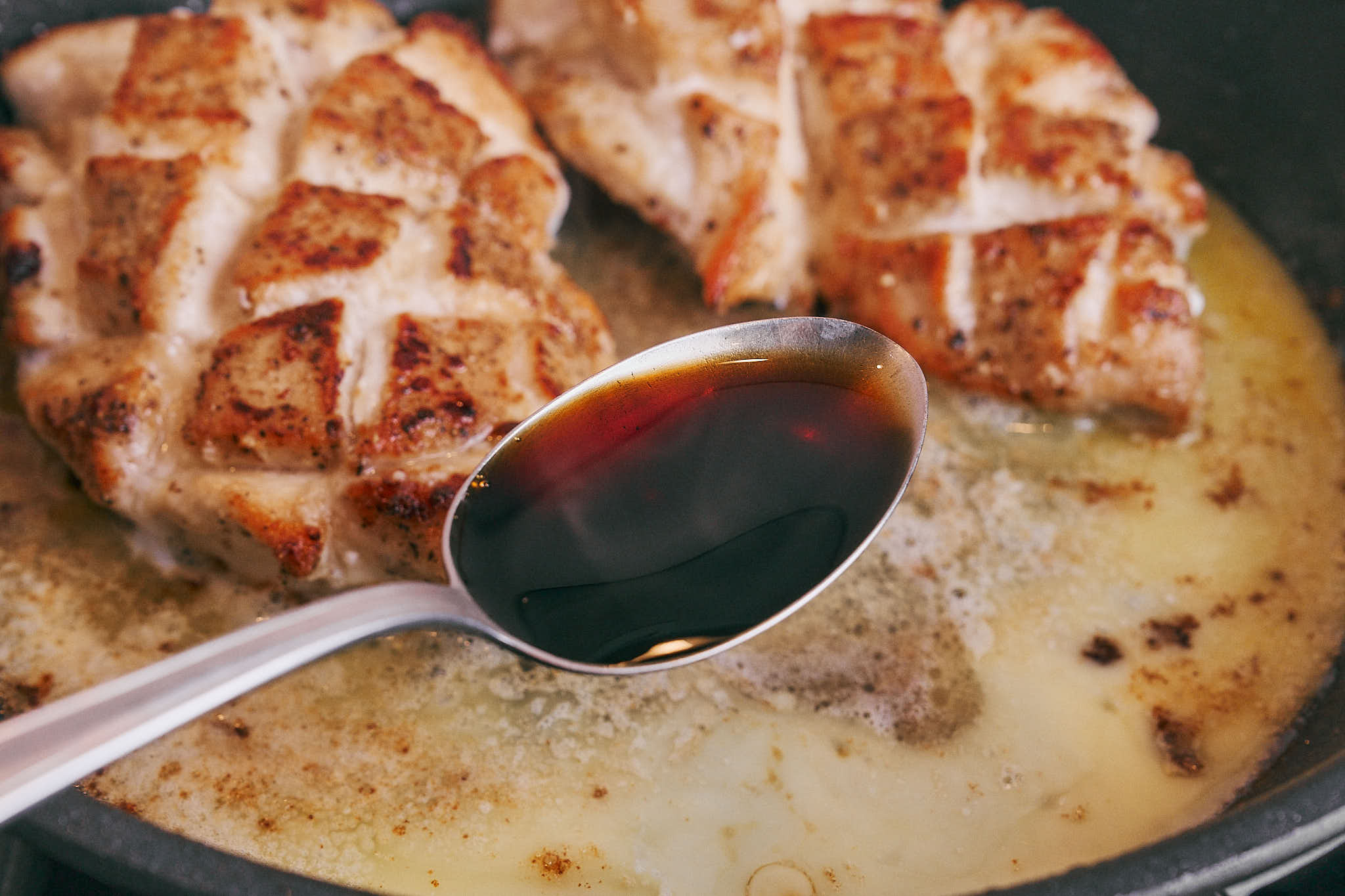 Soy sauce poured into lemon butter sauce with chicken