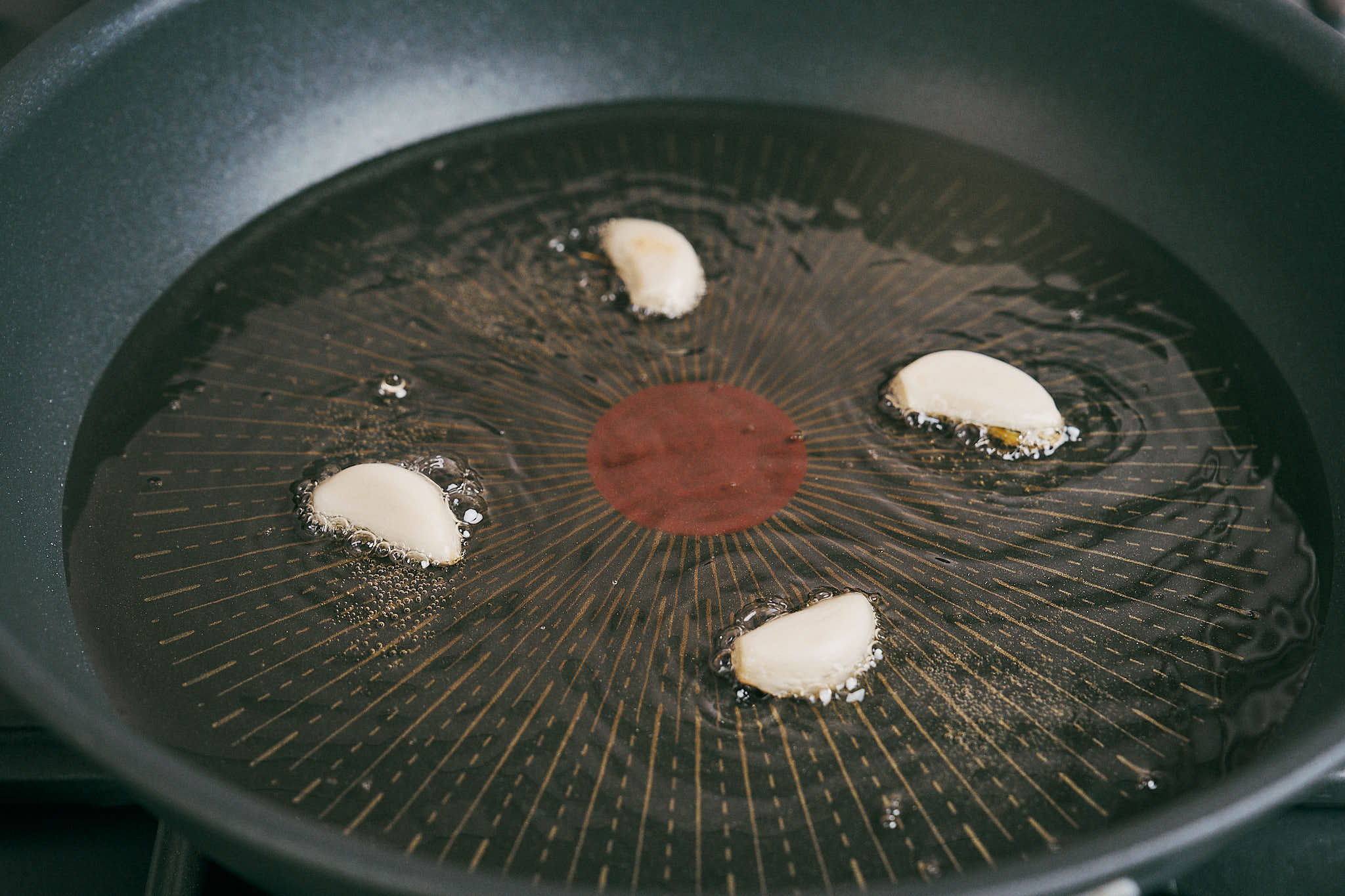 Garlic sizzling in hot oil for beef and rice skillet