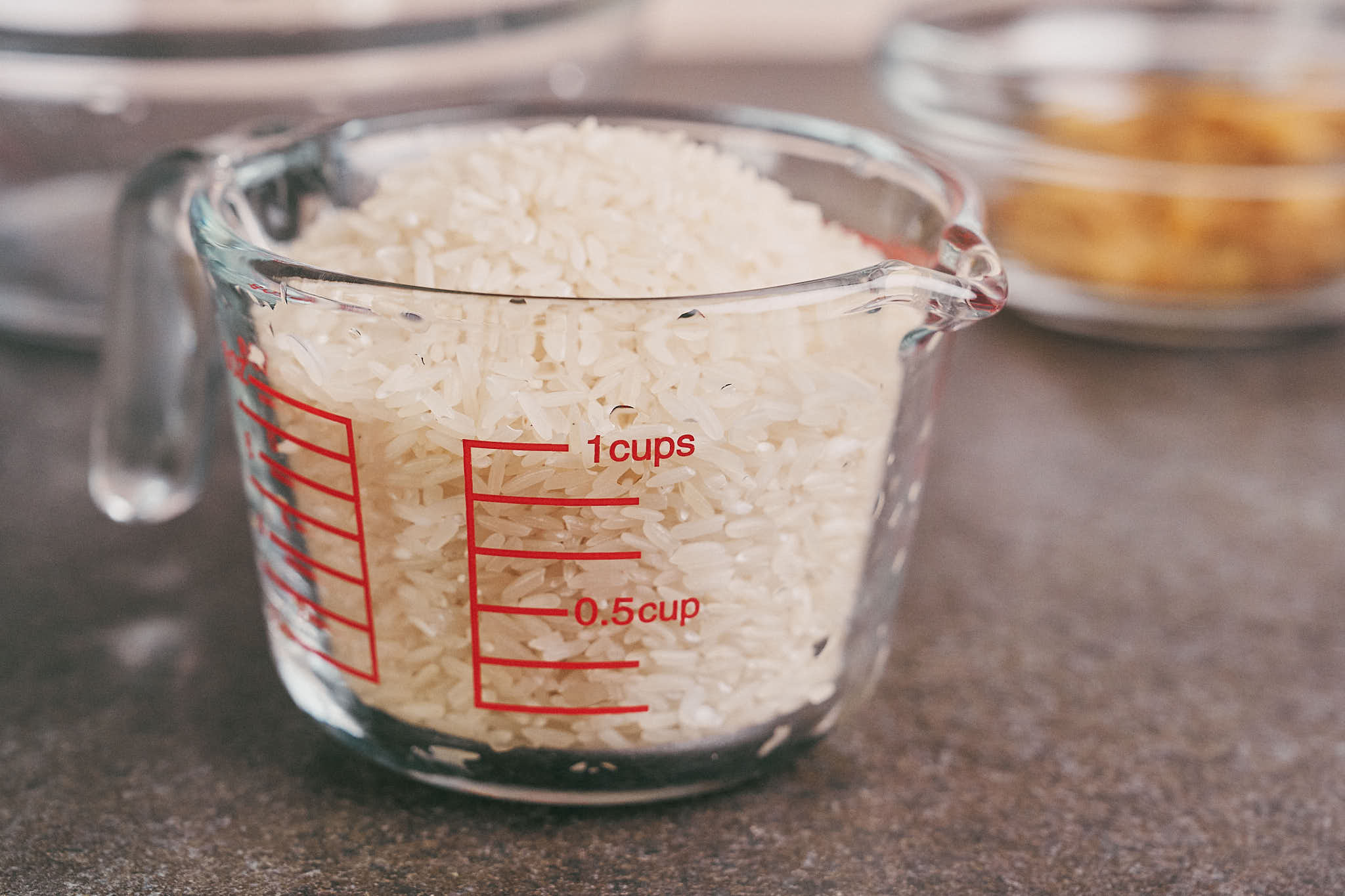 Long-grain white rice measured in glass cup