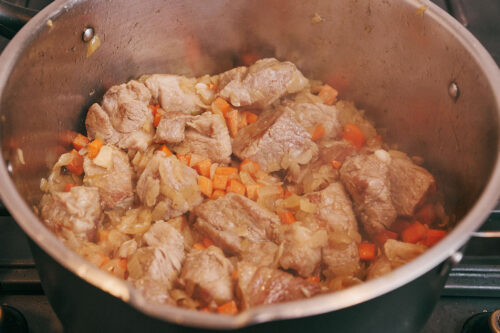 Pork shoulder cooked with onions and carrots