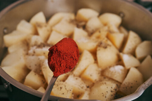 Smoked paprika added to stewed potatoes and pork