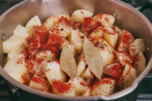 Bay leaves added to stewed potatoes and pork