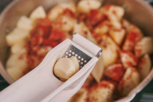 Fresh garlic added to potatoes and pork