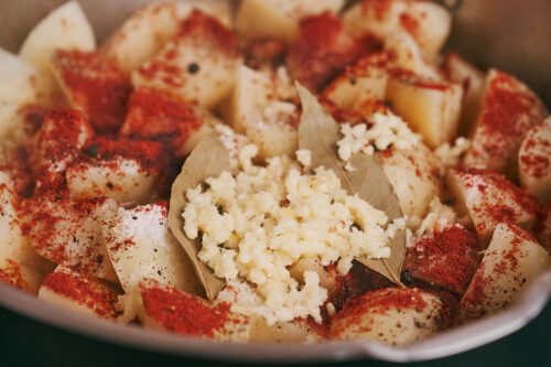 Garlic pressed and added to stewed potatoes and pork