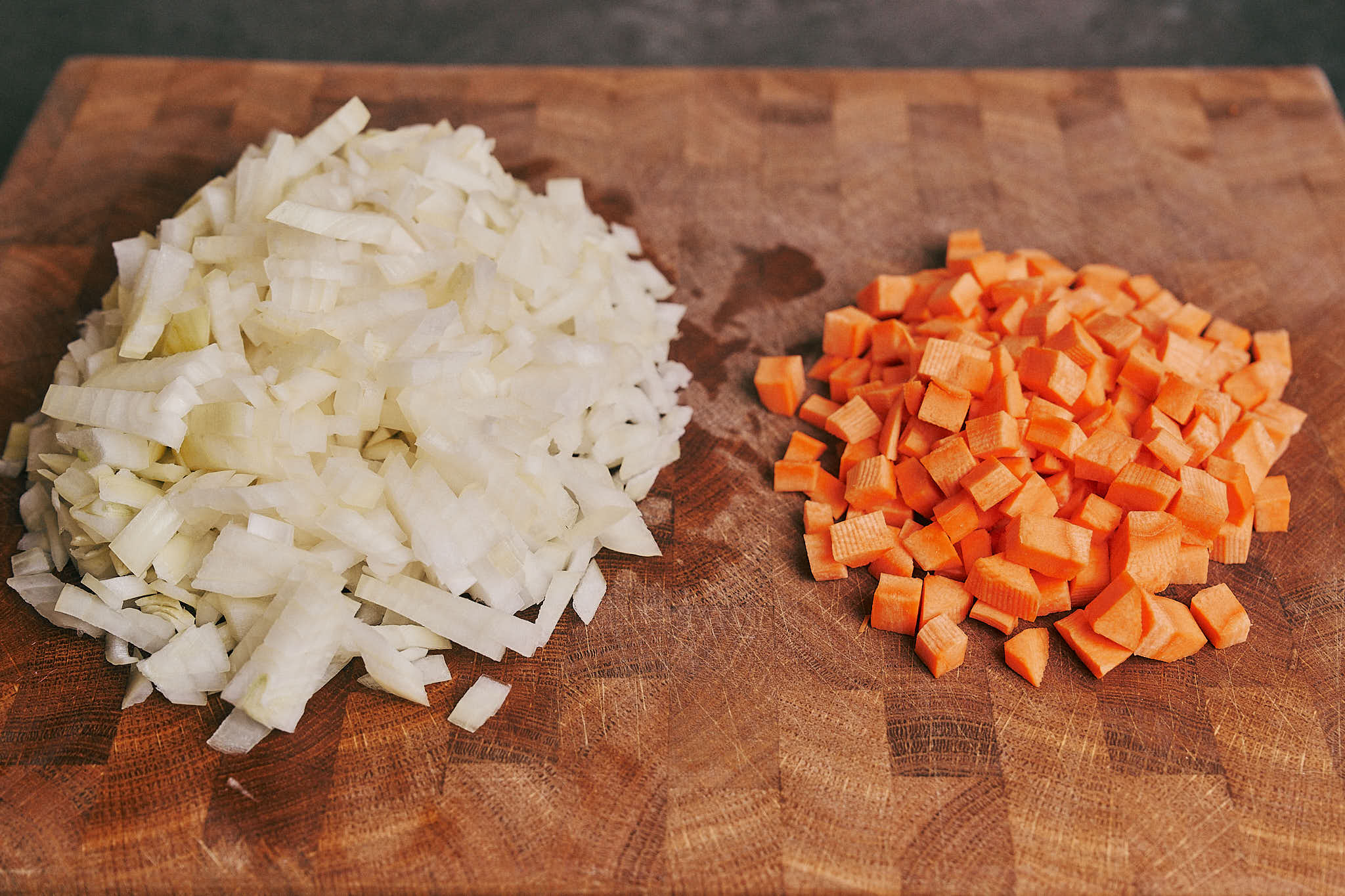 Chopped onion and diced carrots ready for cooking