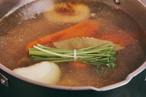 Parsley stem bundle added to beef soup while simmering