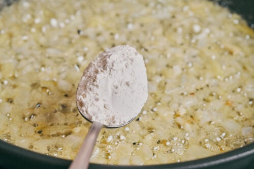 Adding flour to cooked onion to thicken the soup base